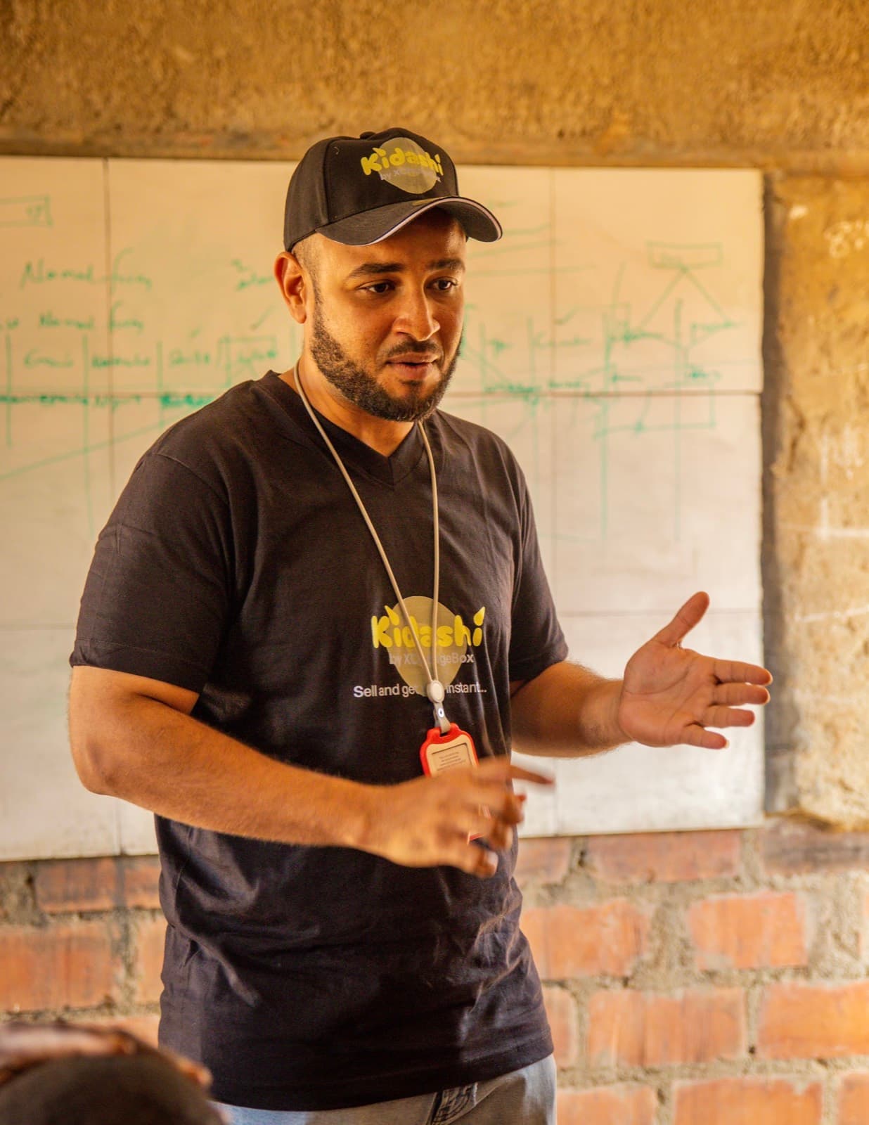 A facilitator explaining accounts and repayment at the whiteboard
