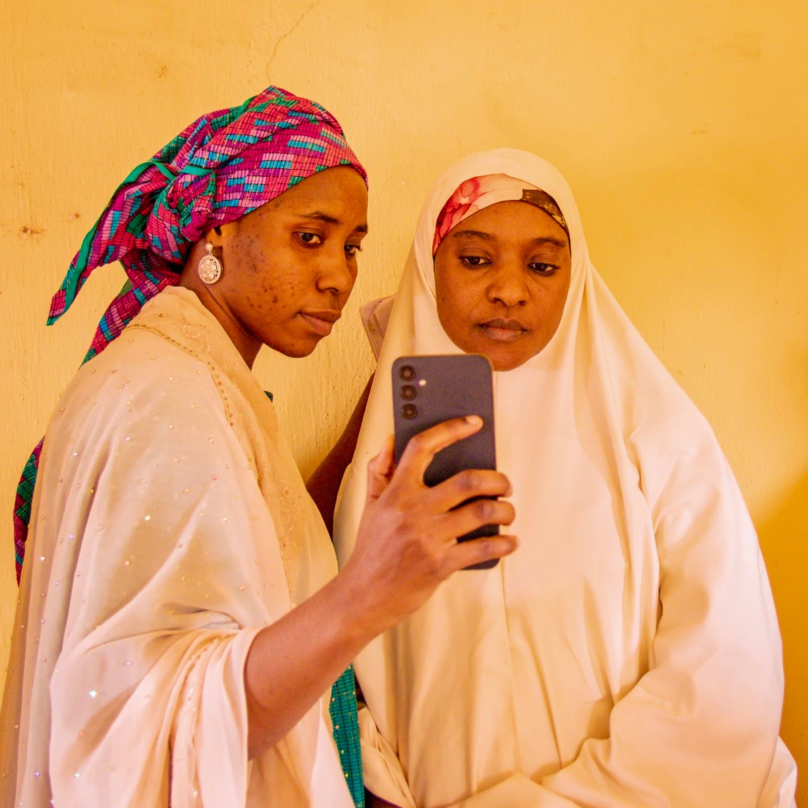 Two women checking their new Kidashi wallet on a phone