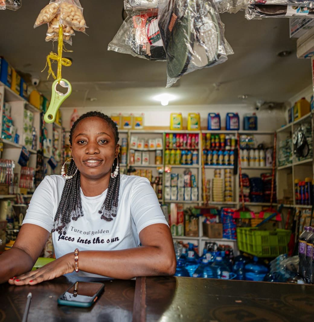 A shop owner at her counter with her phone ready to take payments