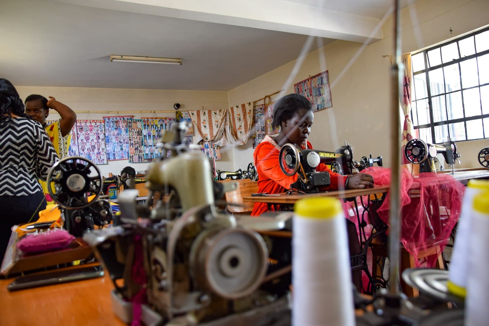Women working at sewing machines on a busy production floor